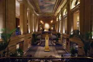 Experience grandeur in our elegant lobby, featuring a stunning staircase, ornate clock tower, and beautiful artwork.