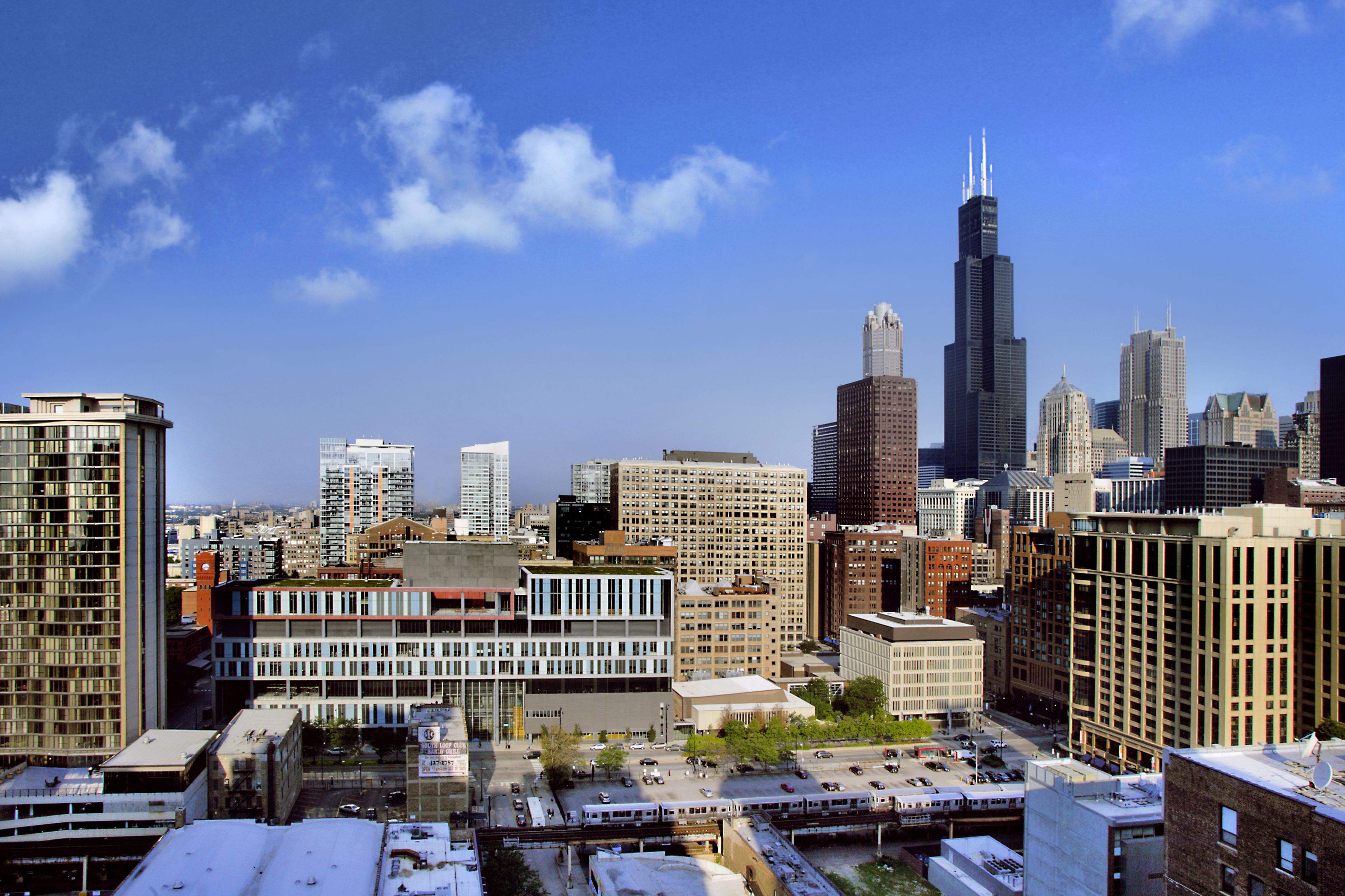 A cityscape with various buildings, including a prominent skyscraper.
