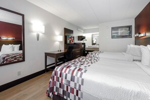 A hotel room with a bed, desk, chair, and a television. - Red Roof Inn Aberdeen (Aberdeen)