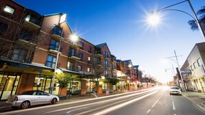 A multi-story building with commercial spaces on the ground floor, including a restaurant and a store. - BreakFree Adelaide (Adelaide)