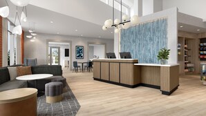 A modern hotel lobby with a reception desk, seating area, and a large window. - Hyatt Select Nashville/Opryland (Nashville)