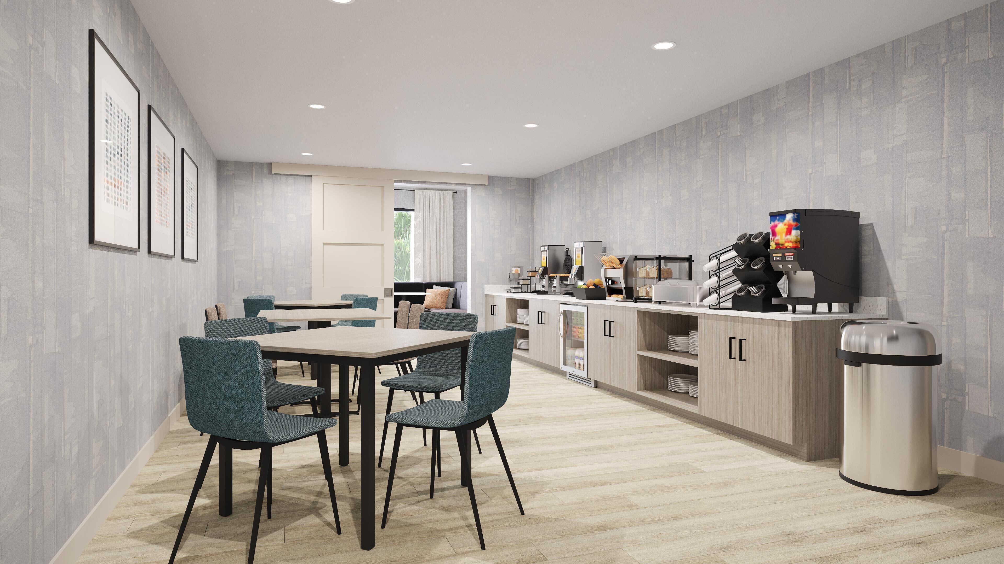 Una cocina moderna con comedor, que cuenta con una encimera con electrodomésticos y un cubo de basura.