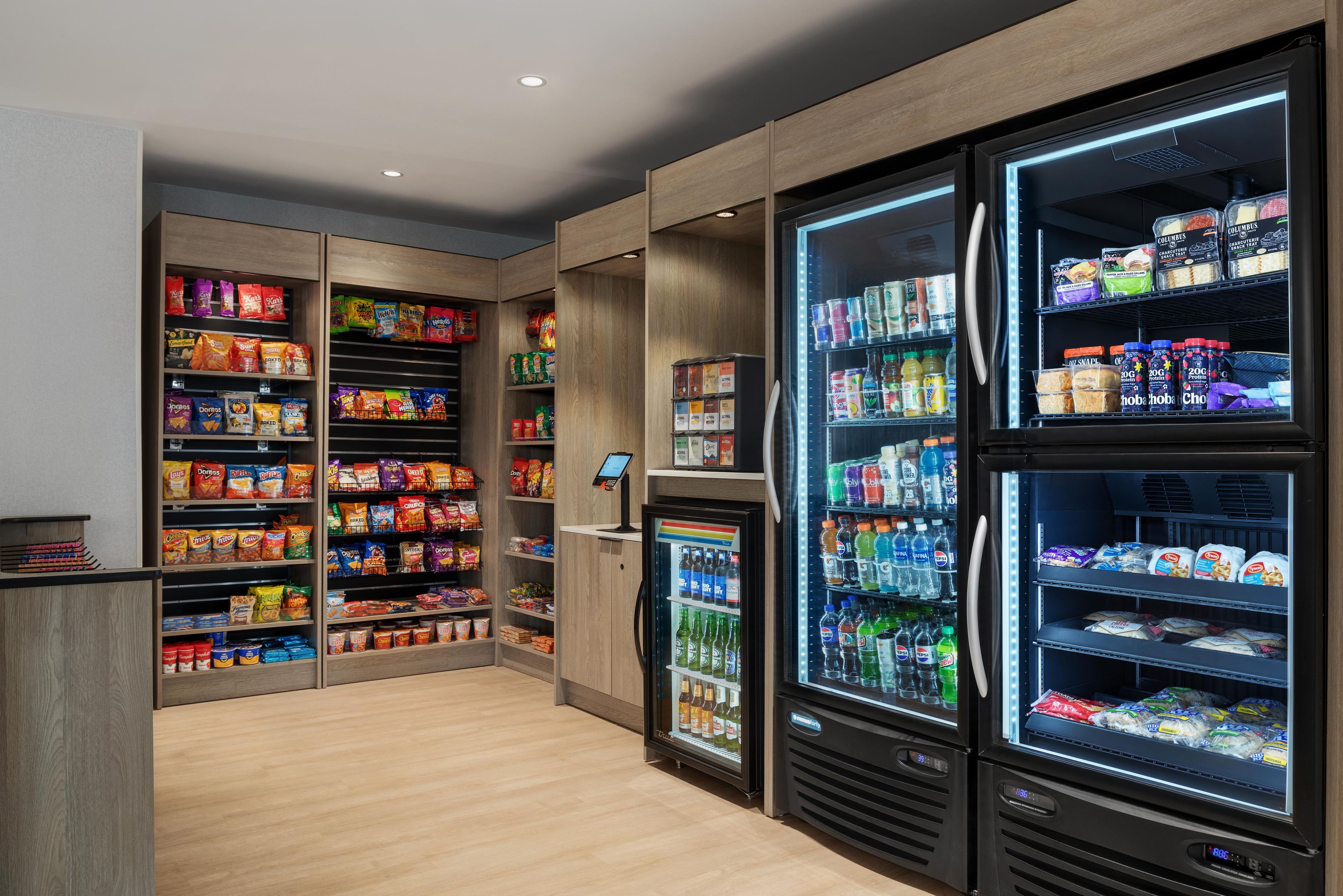 A well-stocked snack and beverage vending area with multiple shelves and refrigerated sections.