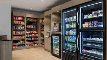 A well-stocked snack and beverage vending area with multiple shelves and refrigerated sections.