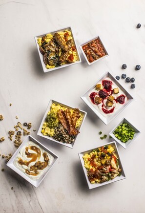 A variety of breakfast dishes arranged on a marble surface. - Hyatt Place Nashville Opryland (Nashville)