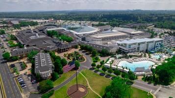 A large building complex with multiple structures, including a prominent dome and a swimming pool area.