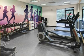 A gym with treadmills, dumbbells, and weight plates. - Hyatt Place Nashville Opryland (Nashville)