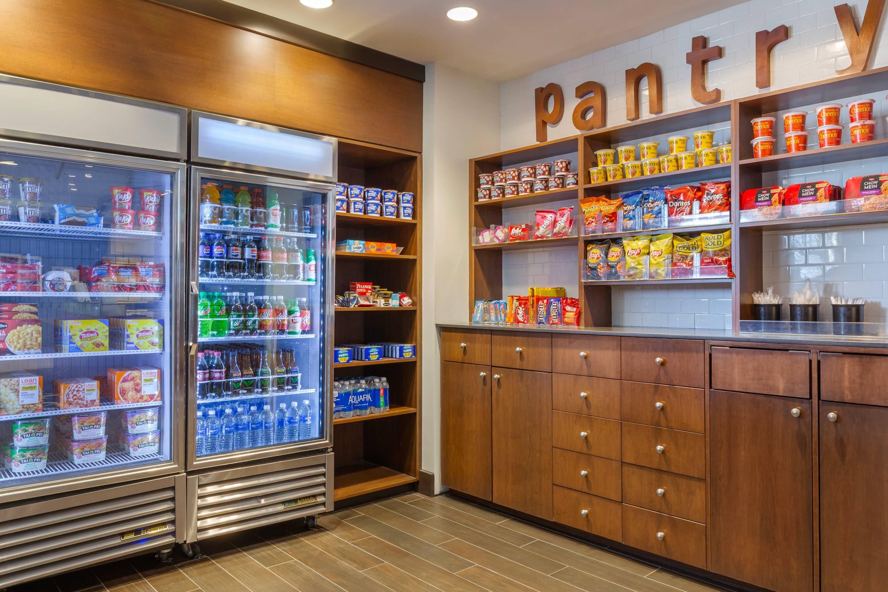 A pantry area with shelves stocked with snacks, beverages, and packaged goods.