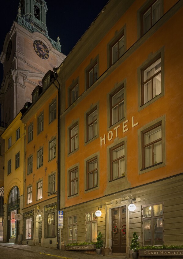 A hotel building with a clock tower in the background. - Lady Hamilton Hotel (Stockholm)