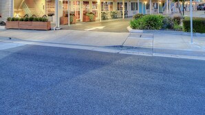 A motel with a two-story structure, a neon sign, and a clear entrance. - The Stevenson Monterey (Monterey)