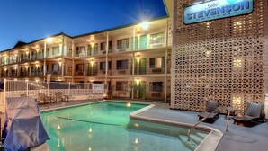 A hotel with a swimming pool, outdoor seating, and a sign reading "The Stevenson Monterey." - The Stevenson Monterey (Monterey)