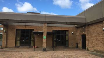 A building with a brick facade, large windows, and a flat roof.