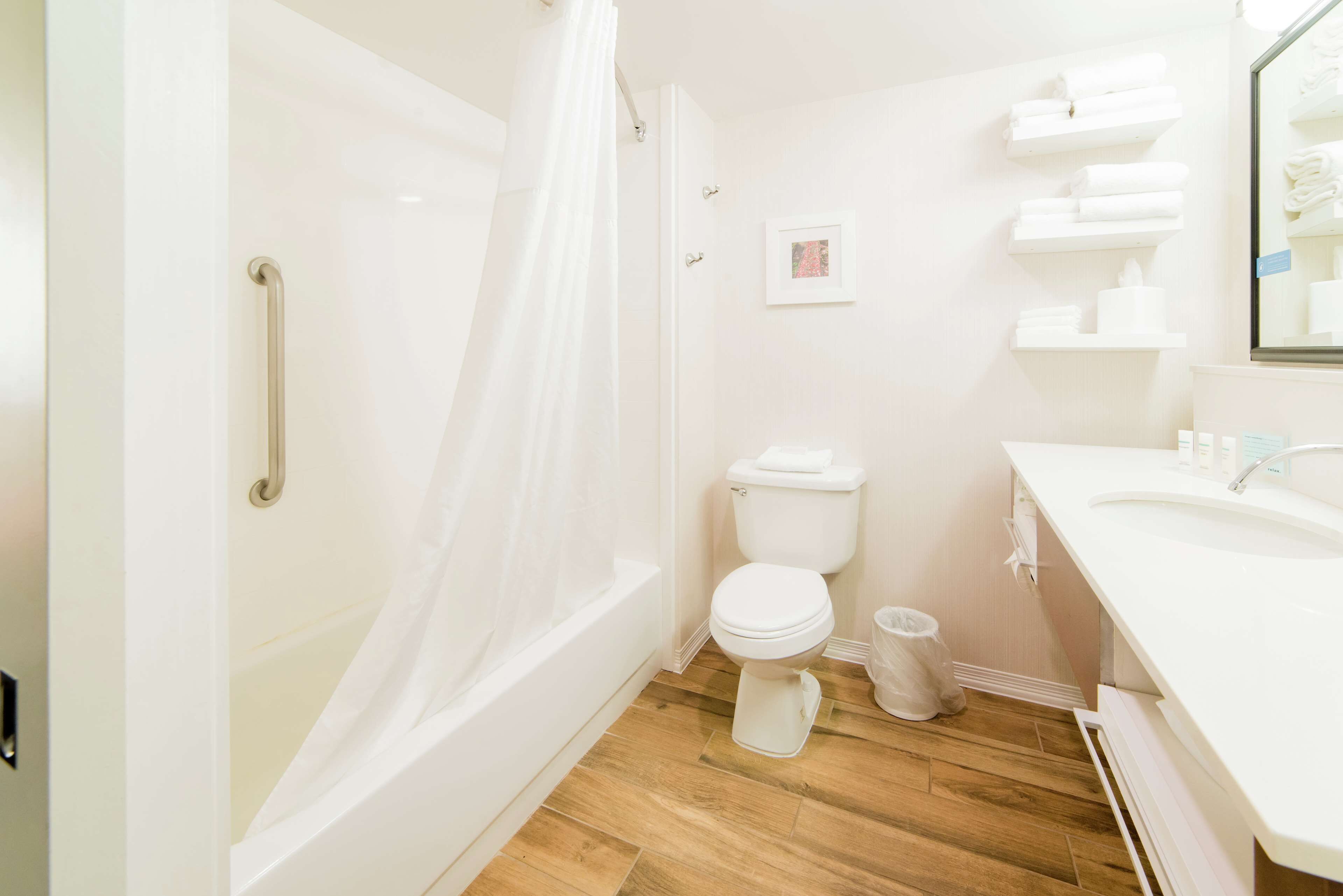 A bathroom with a shower, toilet, and sink.