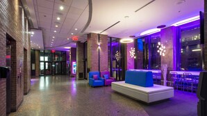 A modern lobby with seating areas, a reception desk, and a glass entrance. - Travelodge Hotel by Wyndham Montreal Centre (Montreal)