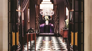 A grand entrance with a chandelier, a checkered floor, and a sign reading "JOEL ROBUCHON". - MGM Grand Hotel & Casino (Las Vegas)