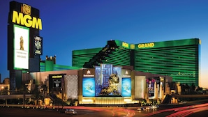 A large hotel with a prominent MGM sign, multiple balconies, and a central statue.