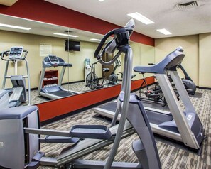 A hotel fitness center with multiple treadmills, a stationary bike, and a stair climber. - Quality Inn & Suites Peoria North (Peoria)