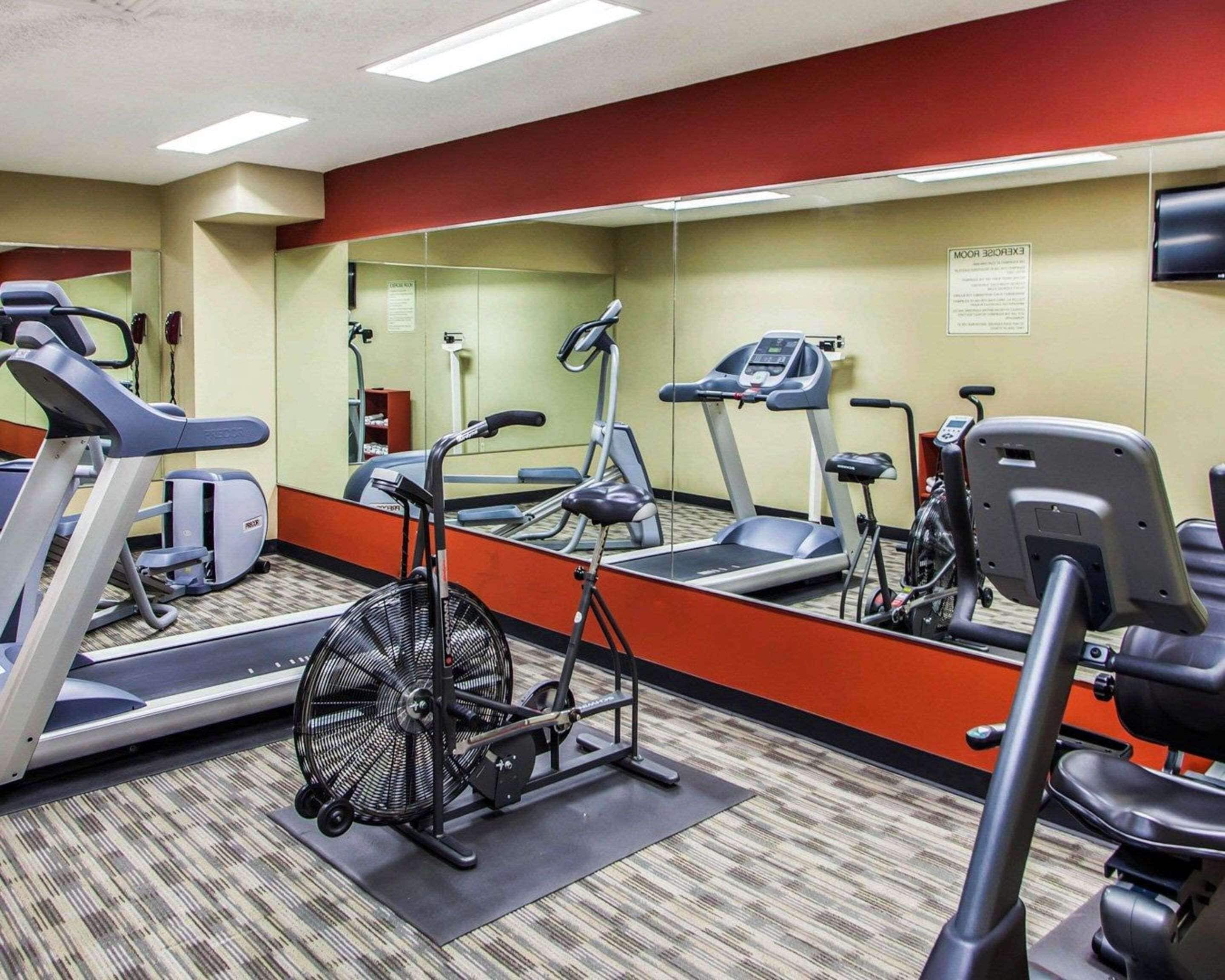 A gym with treadmills, an elliptical, and a stationary bike.