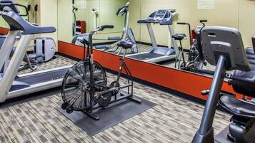 A gym with treadmills, an elliptical, and a stationary bike.