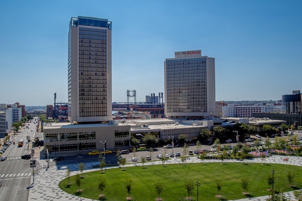 A modern hotel with a prominent Hilton sign, surrounded by a spacious parking lot and a well-maintained lawn. - Hilton St. Louis at the Ballpark (St. Louis)