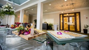A buffet setup with various food items and a decorative centerpiece.