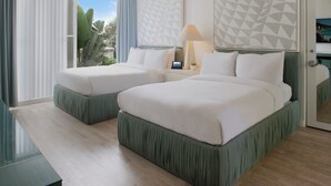 A hotel room with two beds, a large window with curtains, a lamp, and a geometric wall design. - Avalon Hotel Beverly Hills, a Member of Design Hotels (Beverly Hills)