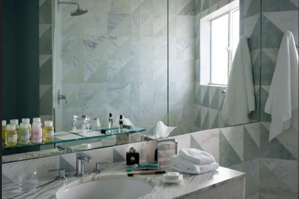 combined shower/bathtub, designer toiletries, hair dryer, bathrobes