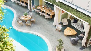 An indoor pool area with lounge chairs, tables, and a seating area with cushions and a sofa. - Avalon Hotel Beverly Hills, a Member of Design Hotels (Beverly Hills)