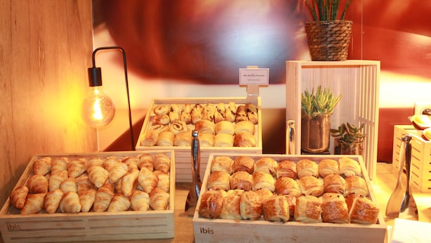 A bakery display with various pastries and a sign indicating the name. - Ibis Lyon Centre (Lyon)