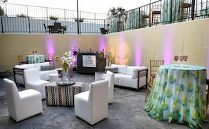 A hotel lobby with white sofas, a reception desk, and a view of the airport. - Crowne Plaza Cleveland Airport by IHG (Middleburg Heights)