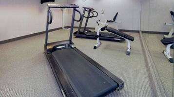 A gym with treadmills and weight machines.