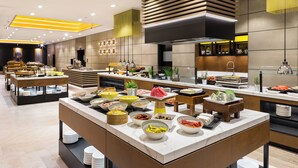 A modern buffet setup with various food items and a clean, contemporary design. - Danubius Hotel Helia (Budapest)