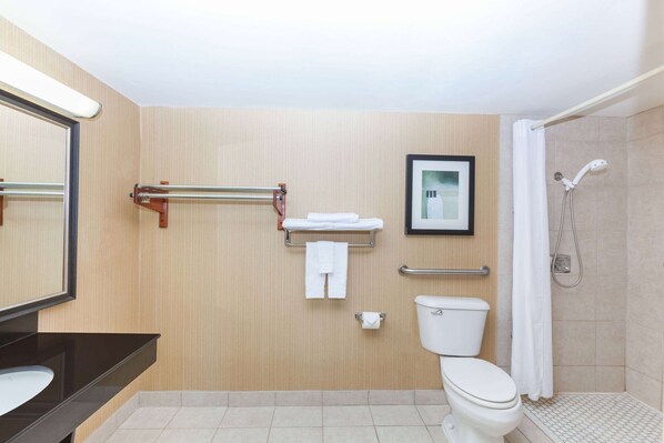 A modern bathroom with a toilet, sink, shower, and a towel rack. - Super 8 by Wyndham Atoka (Atoka)