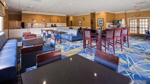 A hotel lobby with seating areas, a reception desk, and a large window. - Best Western Leesburg Hotel & Conference Center (Leesburg)