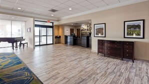 A spacious lobby with a piano, a reception desk, and a large window. - Best Western Leesburg Hotel & Conference Center (Leesburg)
