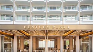A multi-story hotel with a prominent entrance labeled "CENTURY PLAZA".
