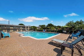 Seasonal outdoor pool, open 9:00 AM to 9:00 PM, pool umbrellas