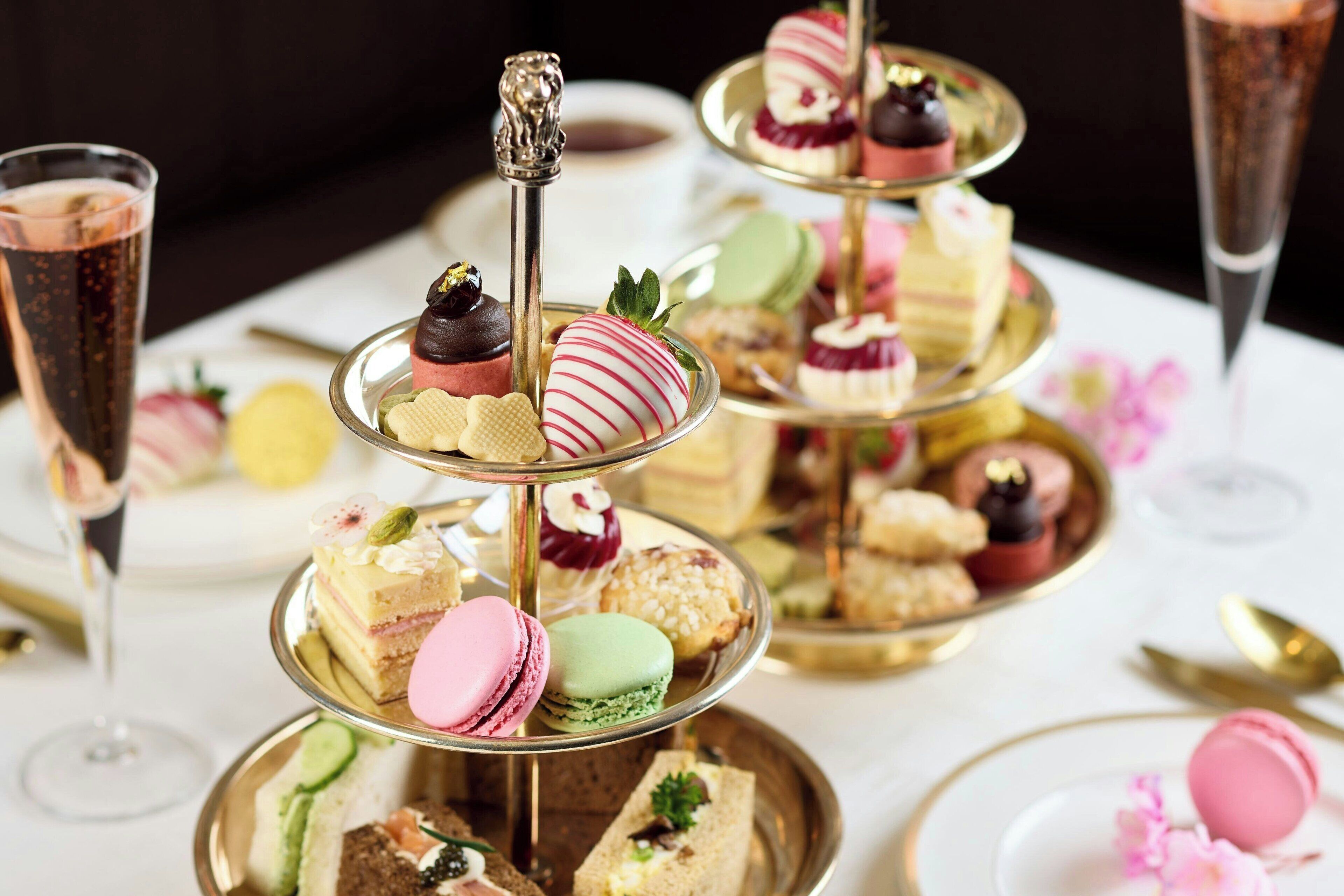 A multi-tiered dessert display with various pastries and macarons.