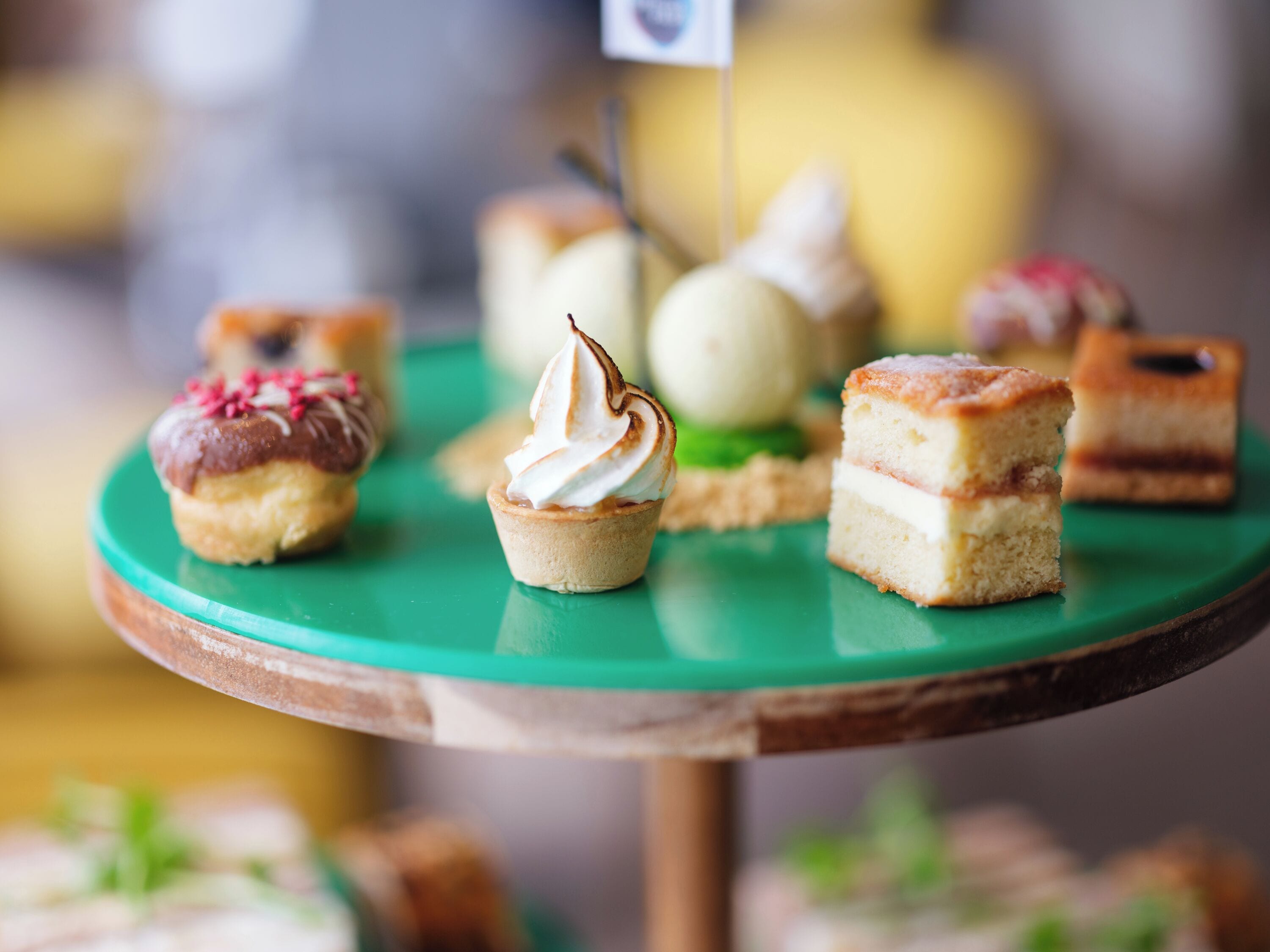 A variety of desserts on a green plate.
