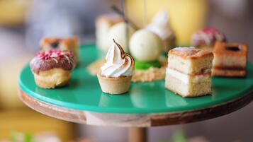 A variety of desserts on a green plate.