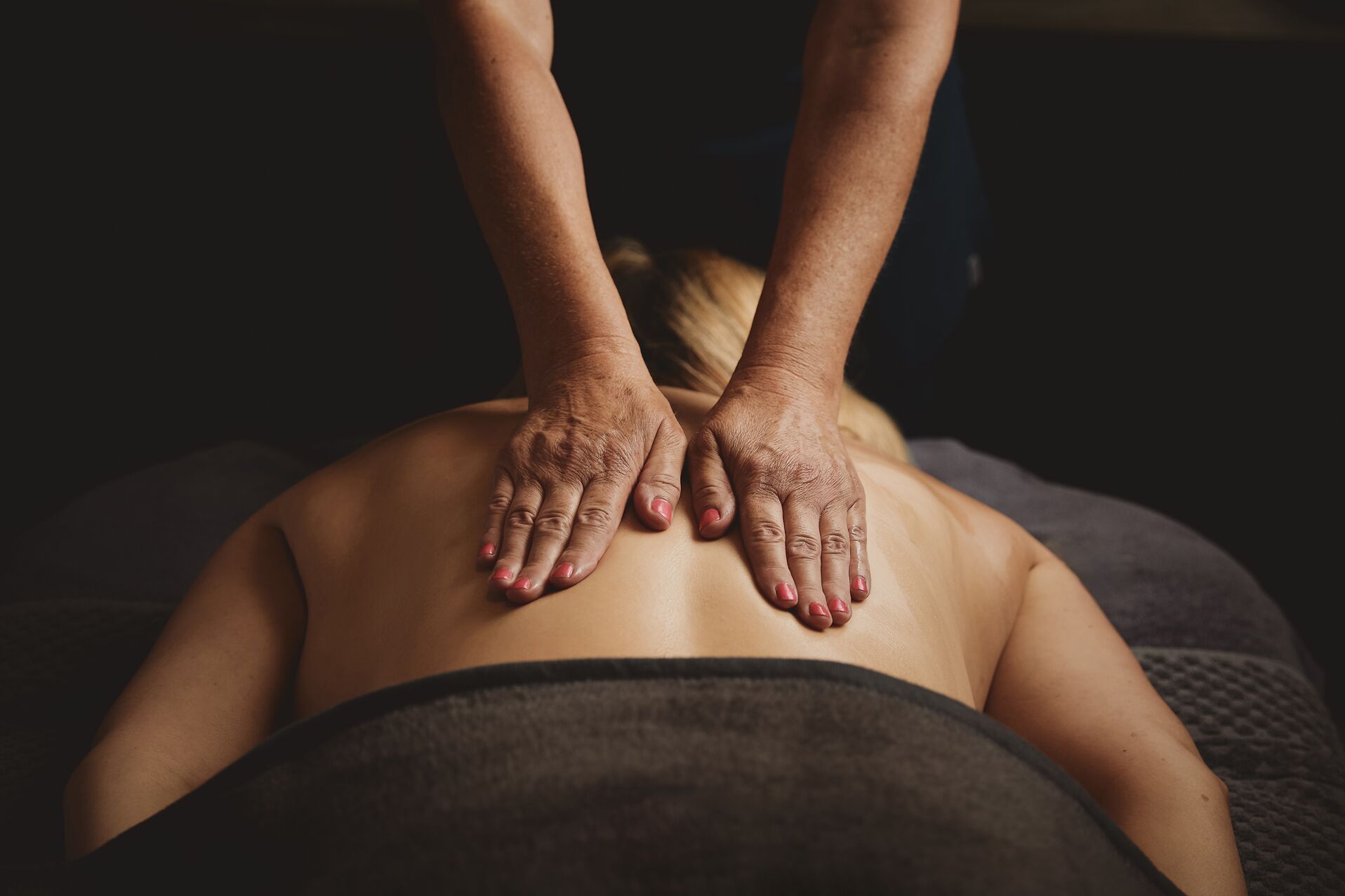 A person receiving a back massage.