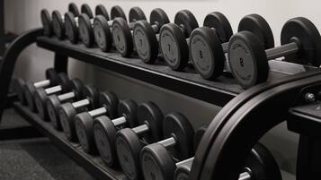 A rack of dumbbells with weights ranging from 4 to 16 kilograms.