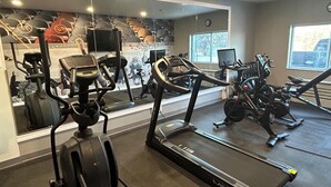 A gym with treadmills, stationary bikes, and exercise equipment. - Best Western Plus Paper Valley Hotel (Appleton)