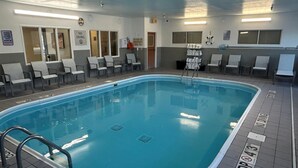 A swimming pool with a no diving sign, lounge chairs, and a lifeguard chair. - Best Western Plus Paper Valley Hotel (Appleton)