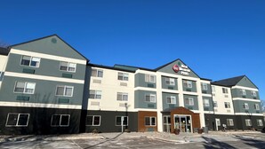 A multi-story hotel with a modern design, featuring a prominent logo on the facade. - Best Western Plus Paper Valley Hotel (Appleton)