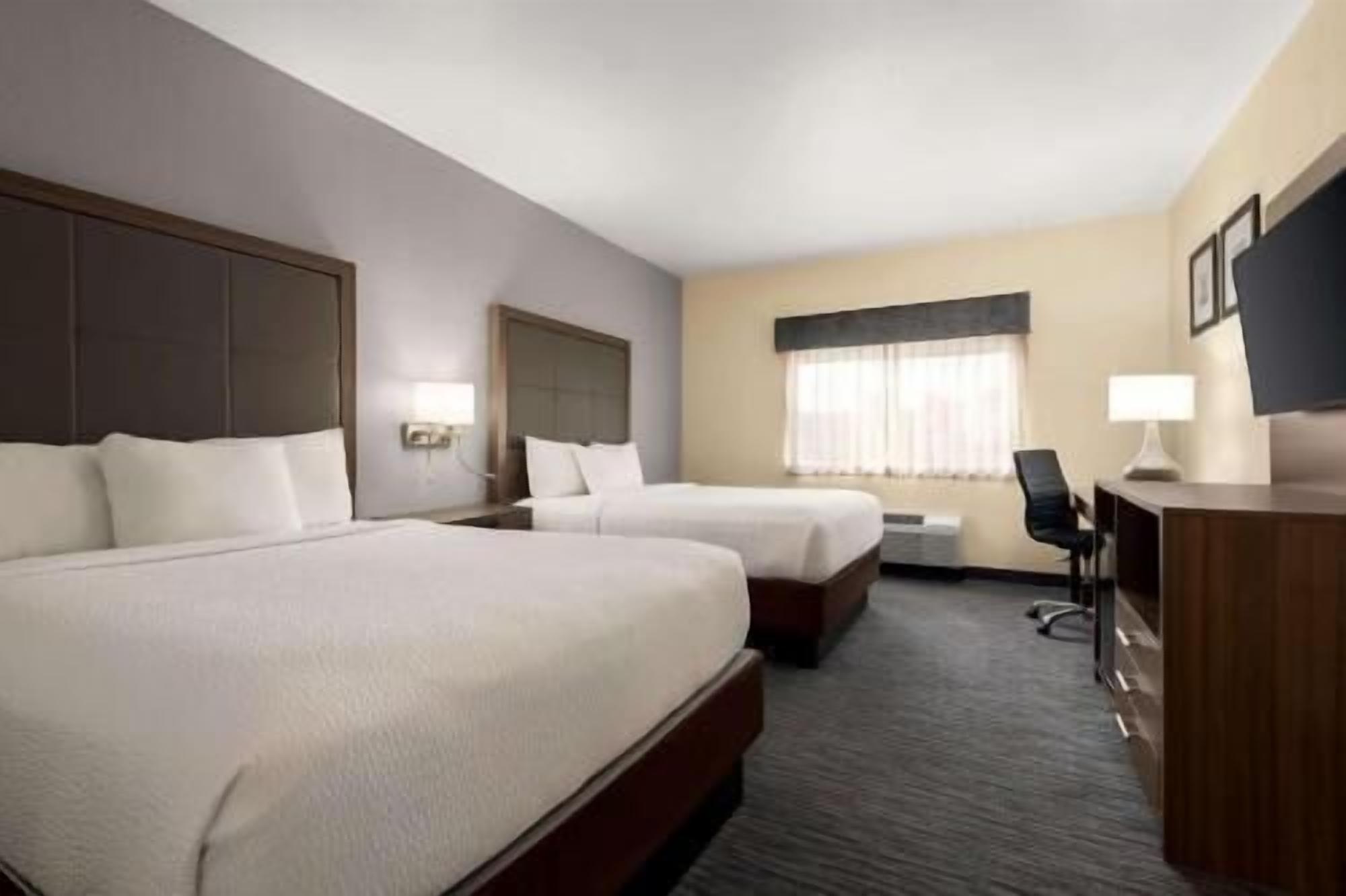 Premium bedding, pillow-top beds, desk, laptop workspace