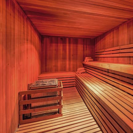 A sauna with wooden benches and a bench seat.