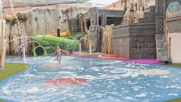 Children can splash and play in the large, shallow pool surrounded by a play structure and artificial rock formations.