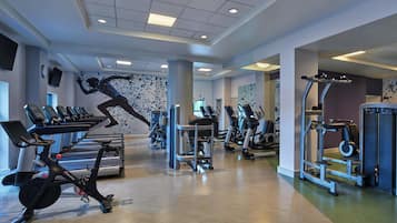 A gym with treadmills, stationary bikes, and weight machines.