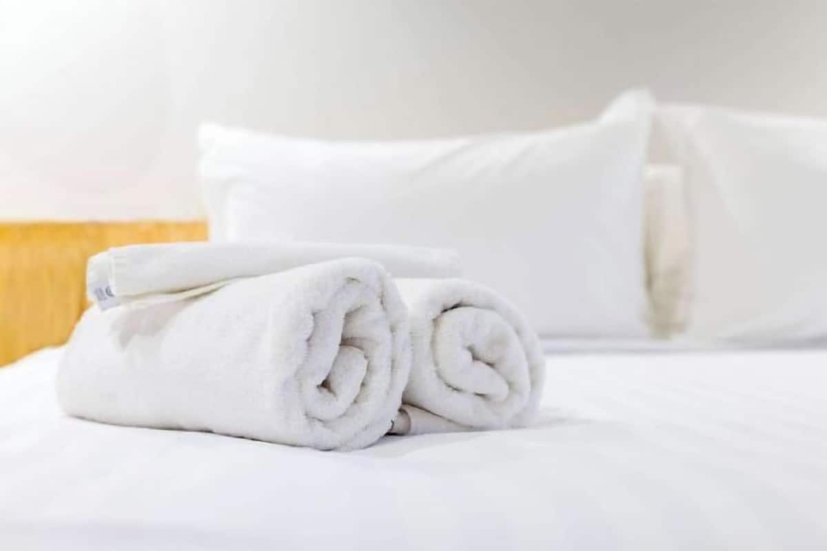 Premium bedding, desk, laptop workspace, blackout drapes